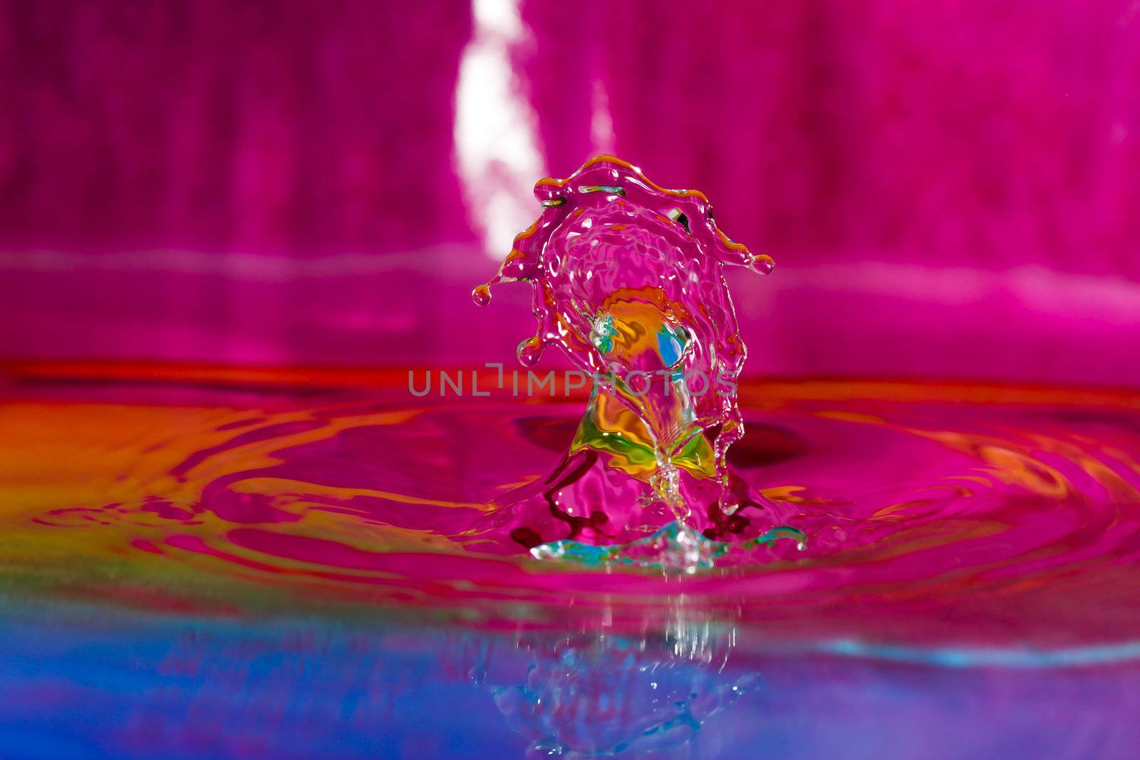 Macro photography of colorful water drop collision sculpture.