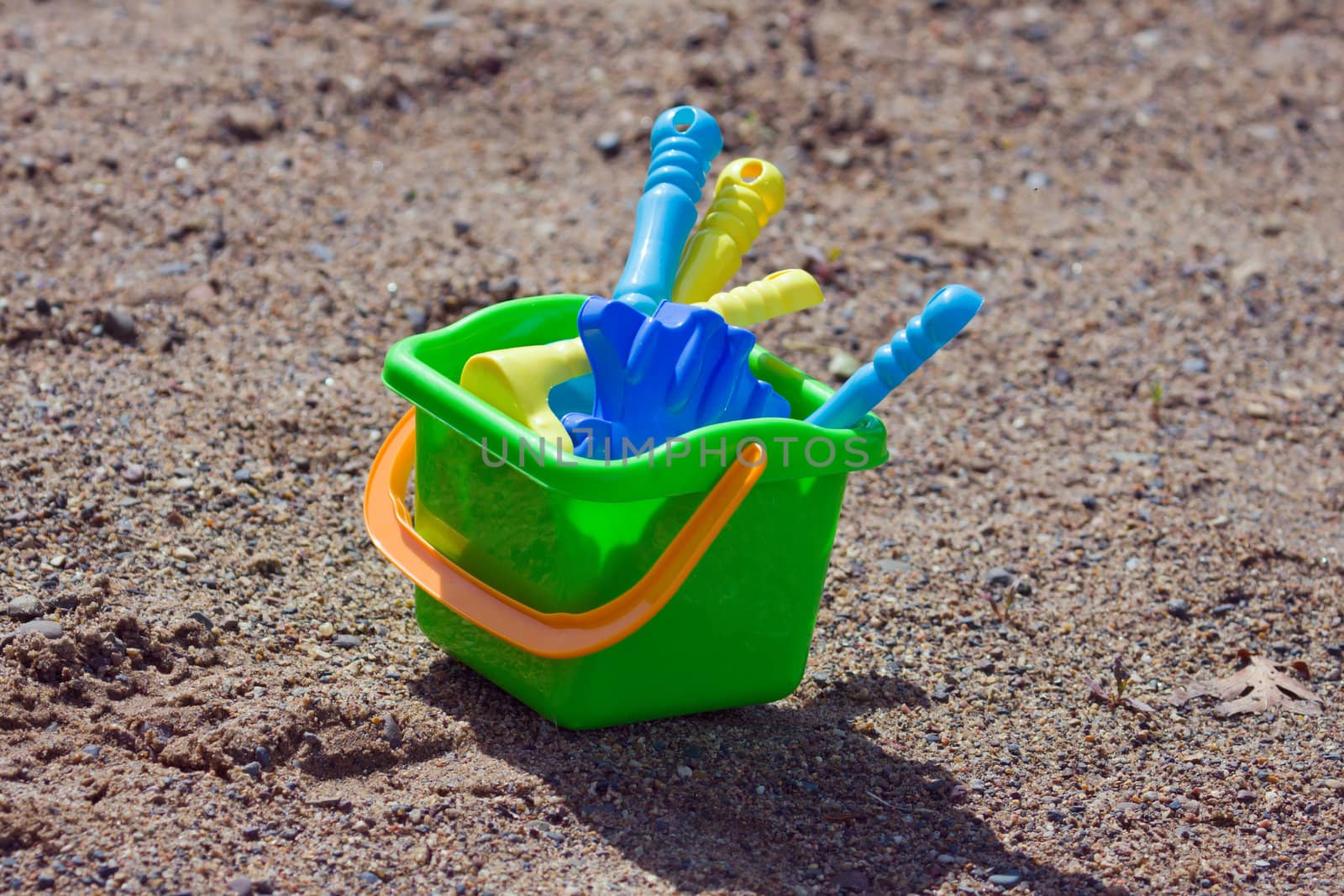 A set of kids sand tools on the beach.
