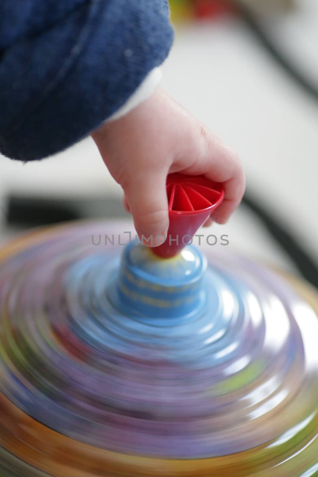 Child hand on spinner in motion