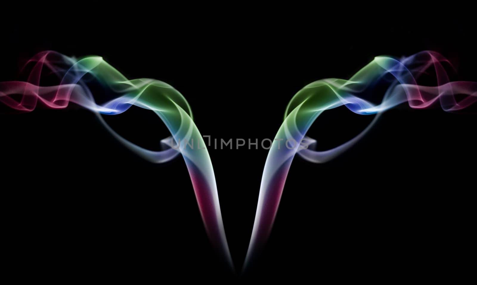 Colored smoke abstract on black background and mirrored image.