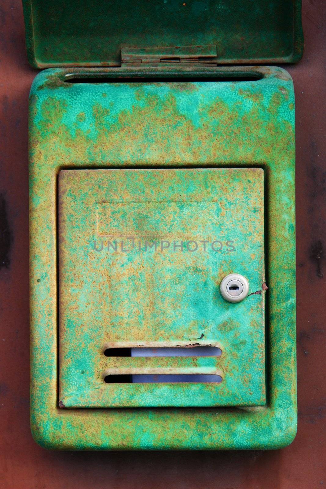 Old rusty mailbox on the shabby gate in Italy