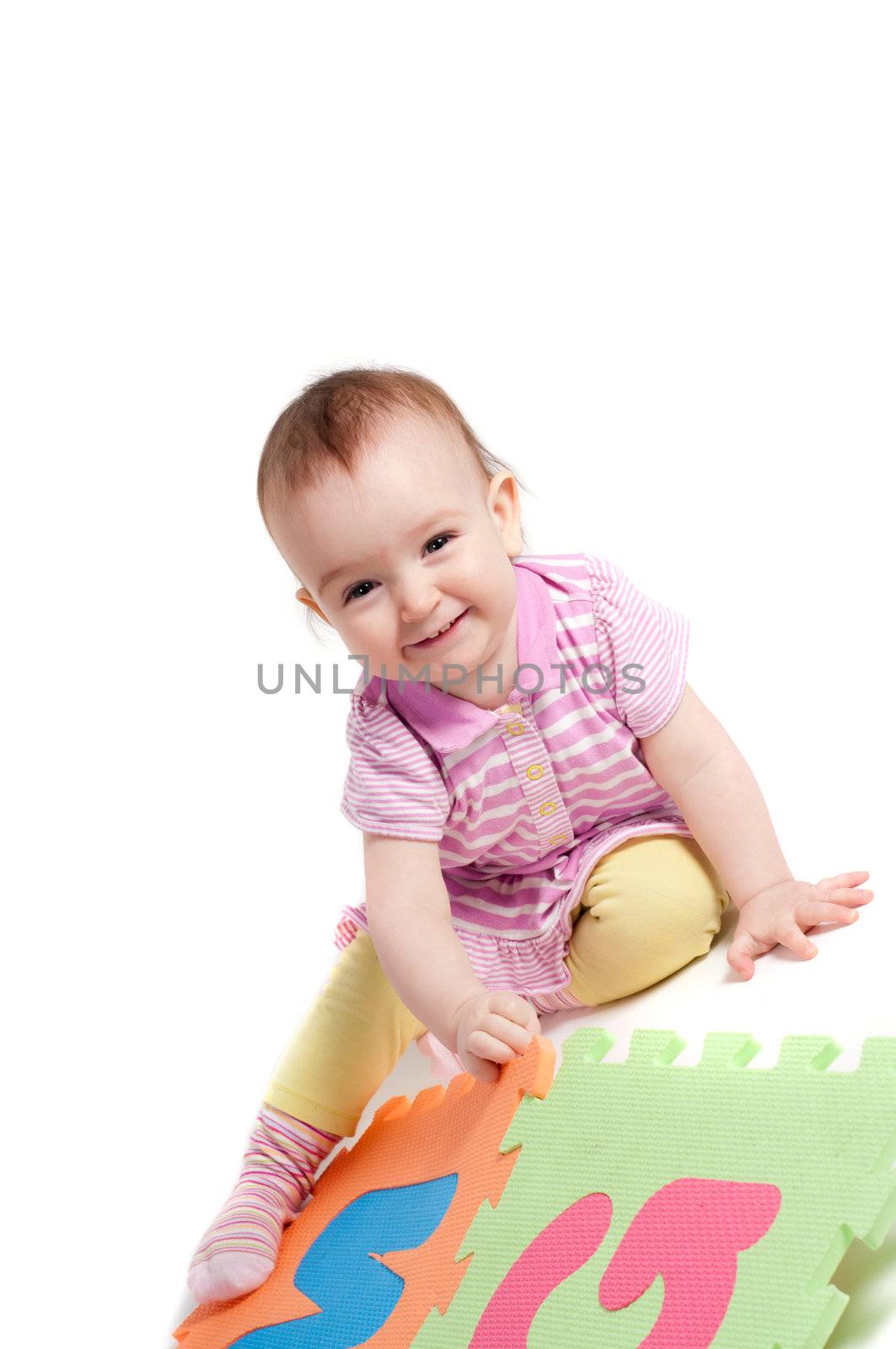 Shot of little cute baby playing with letters