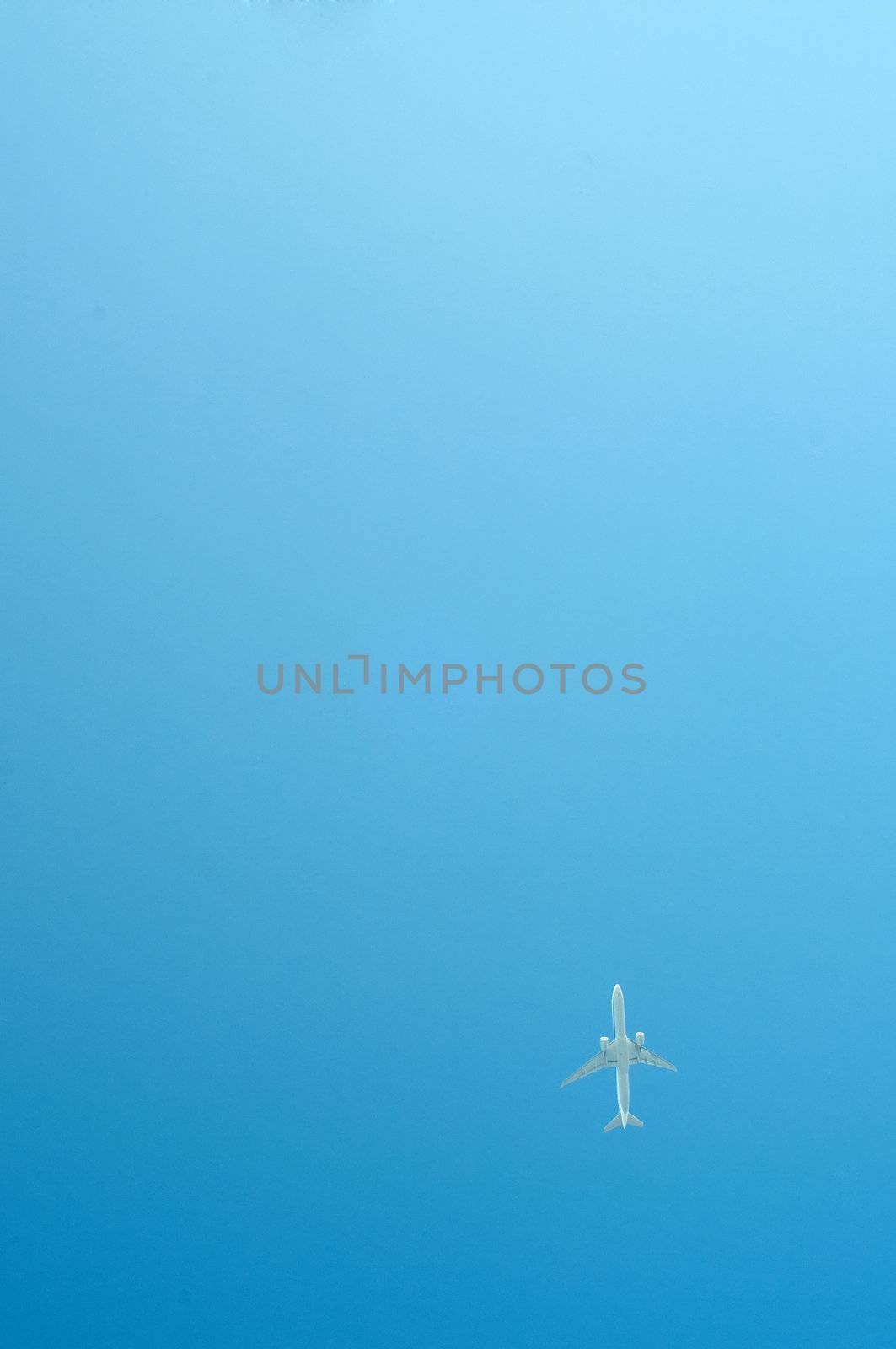 Small airplane on blue sky flying high