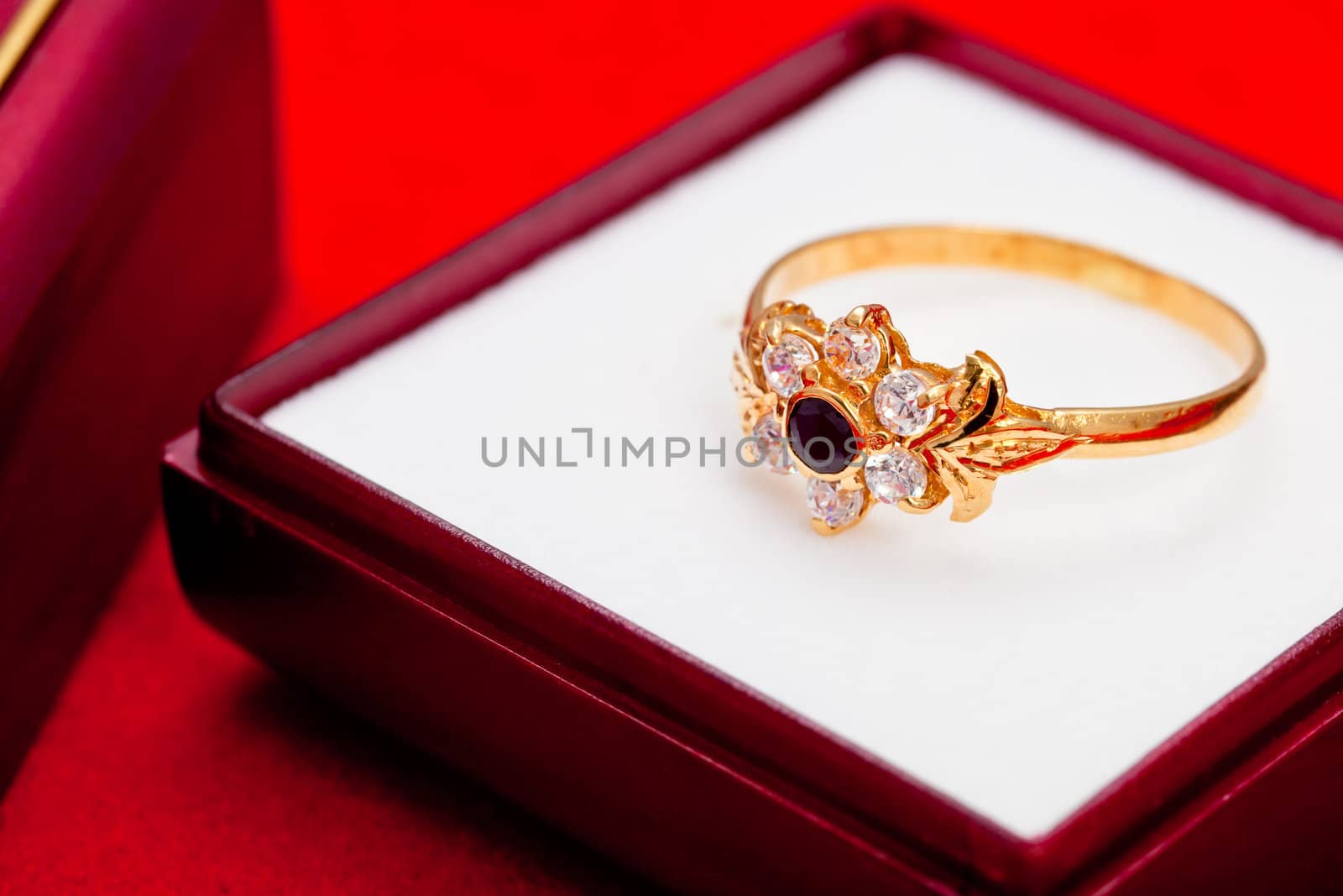 Fantastic gold ring adorned with one blue  and several white zirconia