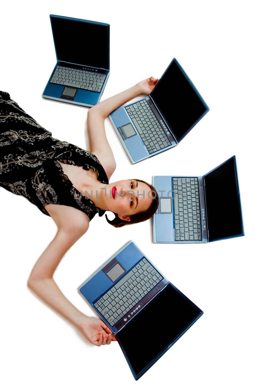 Beautiful woman lying near laptops and posing isolated over white