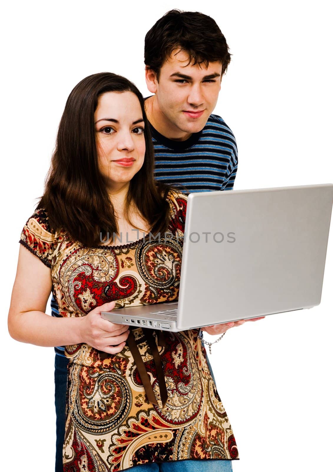 Couple using a laptop and smiling isolated over white