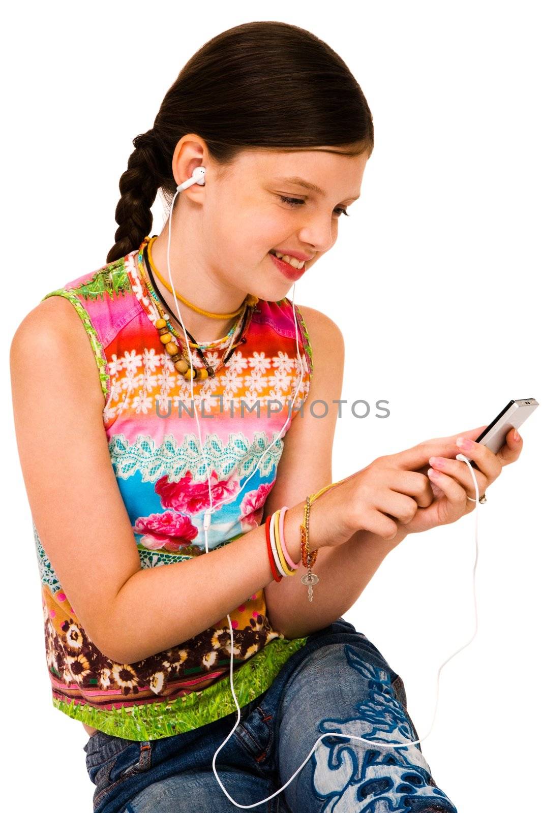 Cute girl listening to music on MP3 player isolated over white