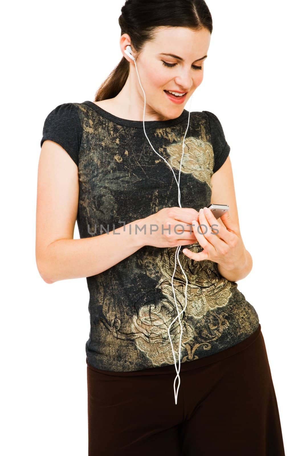Smiling woman listening to music on MP3 player isolated over white