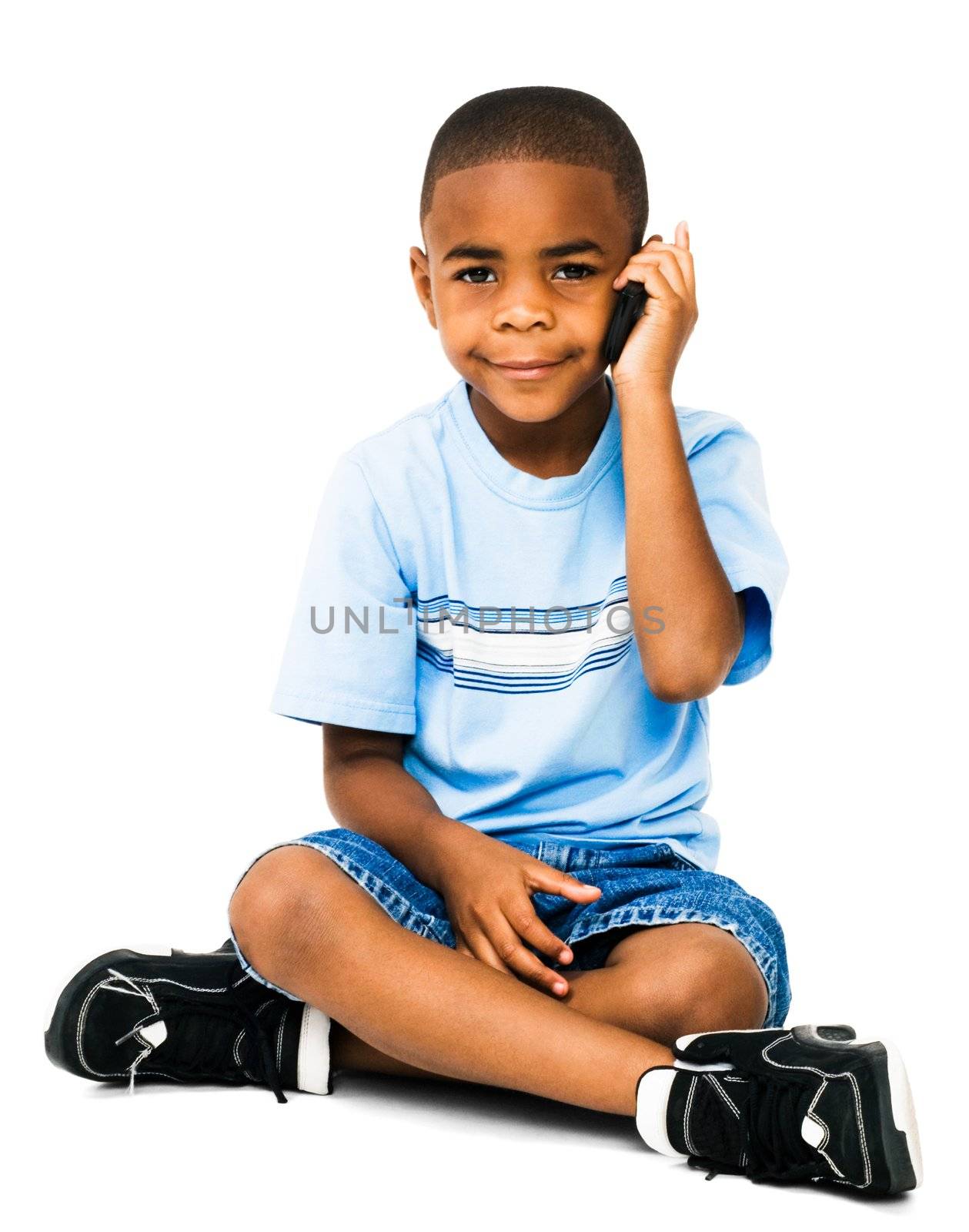 Smiling boy talking on a mobile phone isolated over white