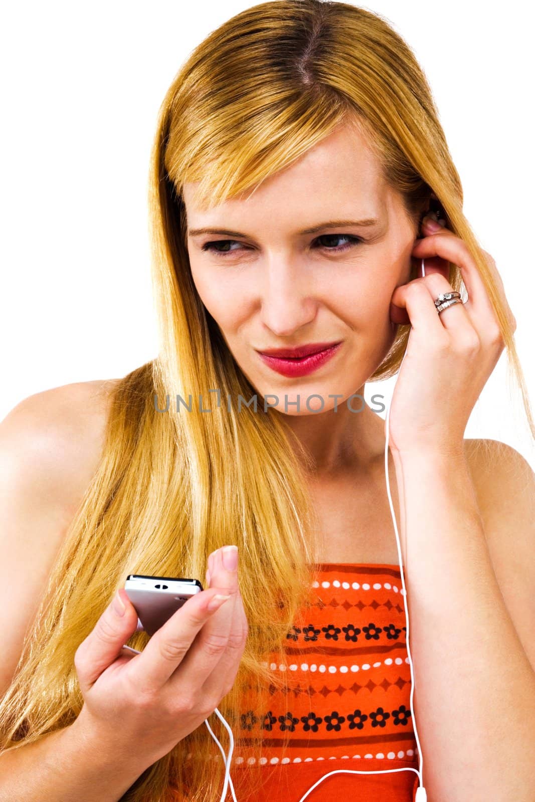 Young woman listening to music on MP3 player isolated over white