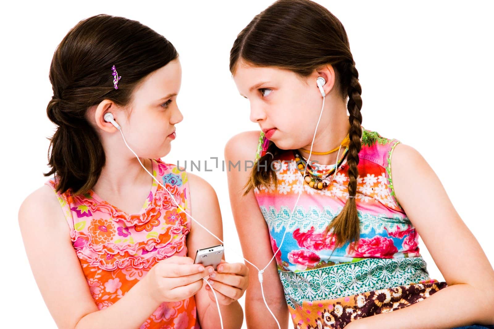 Caucasian girls listening to MP3 player isolated over white