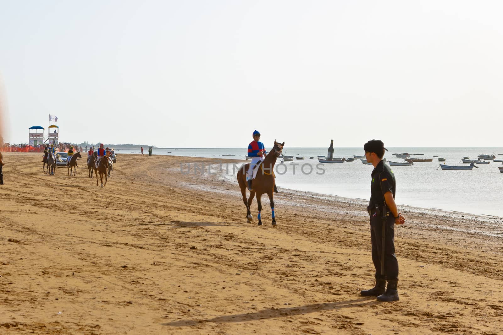 SANLUCAR DE BARRAMEDA, CADIZ, SPAIN - AUGUST 10: Unidentified riders at the start of race horses on Sanlucar de Barrameda beach on August 10, 2011 in Sanlucar de Barrameda, Cadiz, Spain.