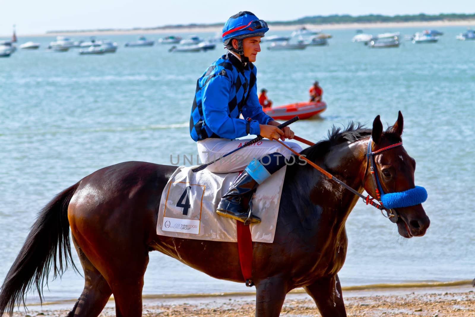 SANLUCAR DE BARRAMEDA, CADIZ, SPAIN - AUGUST 10: Unidentified rider at the start of race horses on Sanlucar de Barrameda beach on August 10, 2011 in Sanlucar de Barrameda, Cadiz, Spain.