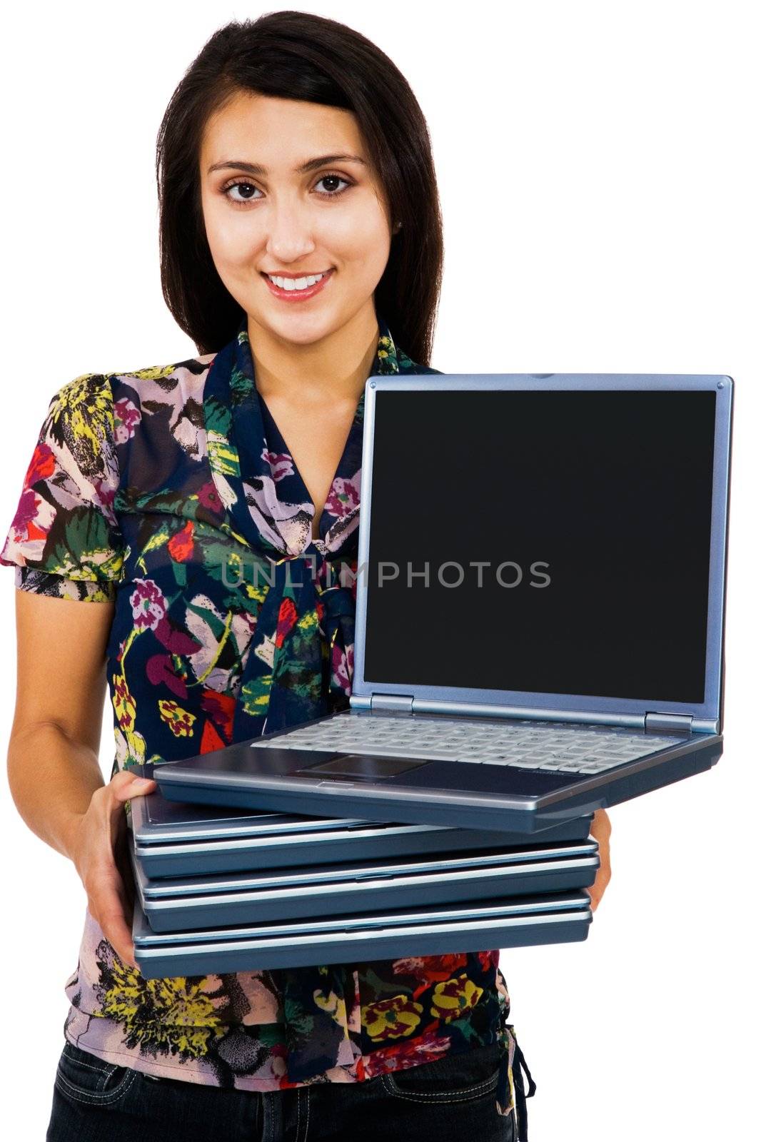 Portrait of a woman holding a stack of laptops isolated over white