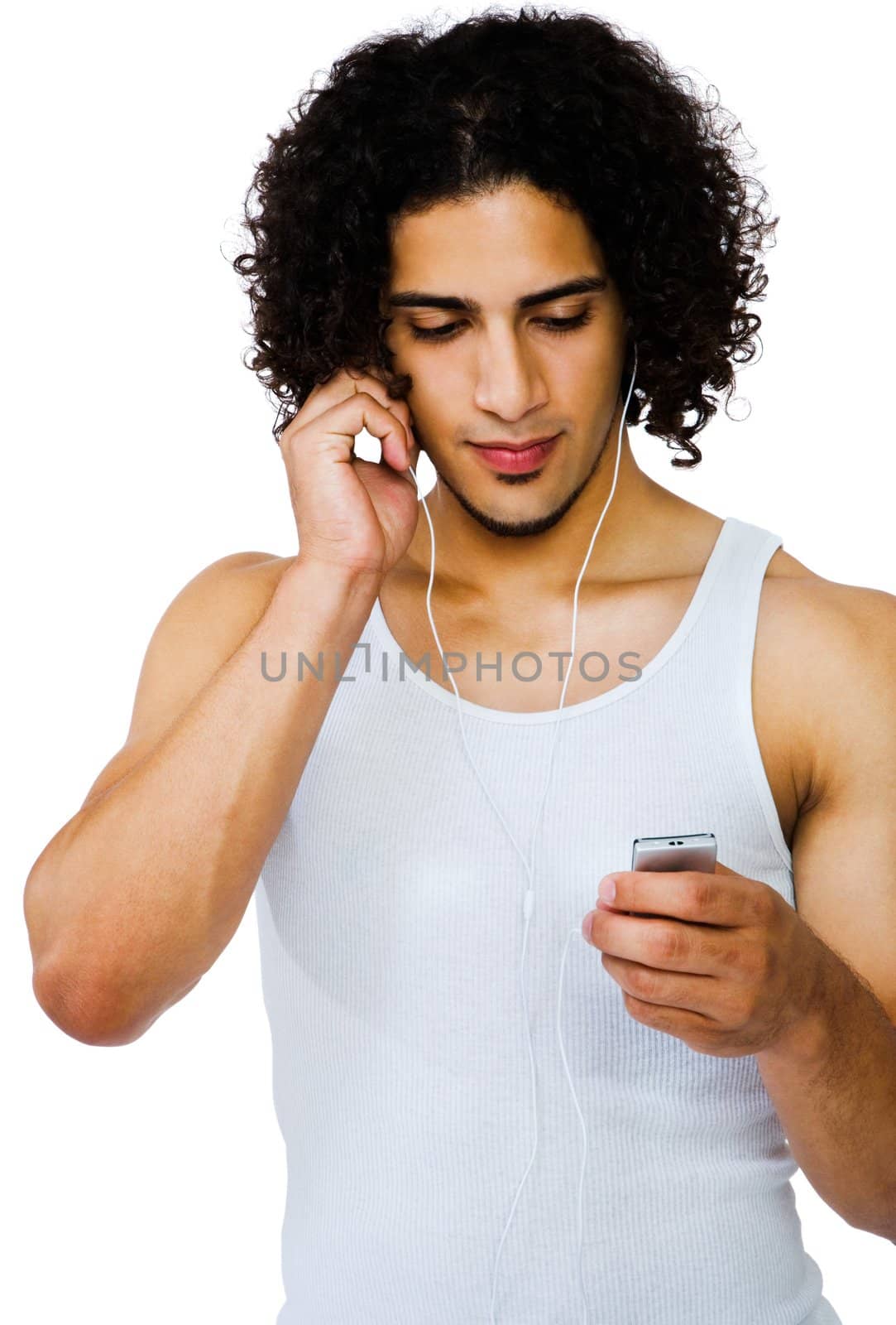 Latin American man listening to music on a MP3 player isolated over white