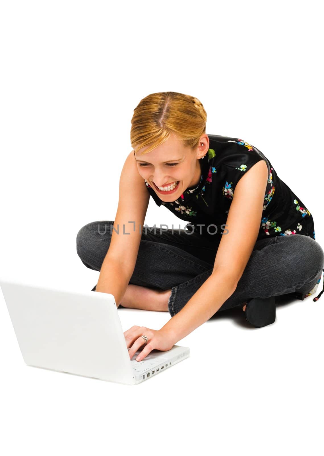 Close-up of a woman using a laptop and smiling isolated over white