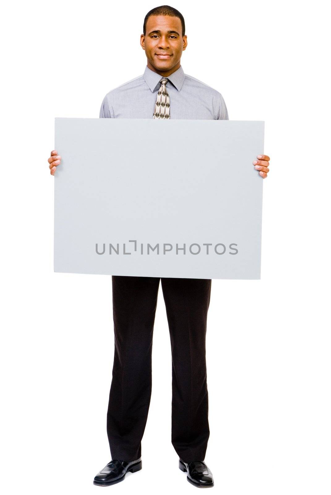 Smiling businessman showing a blank placard isolated over white