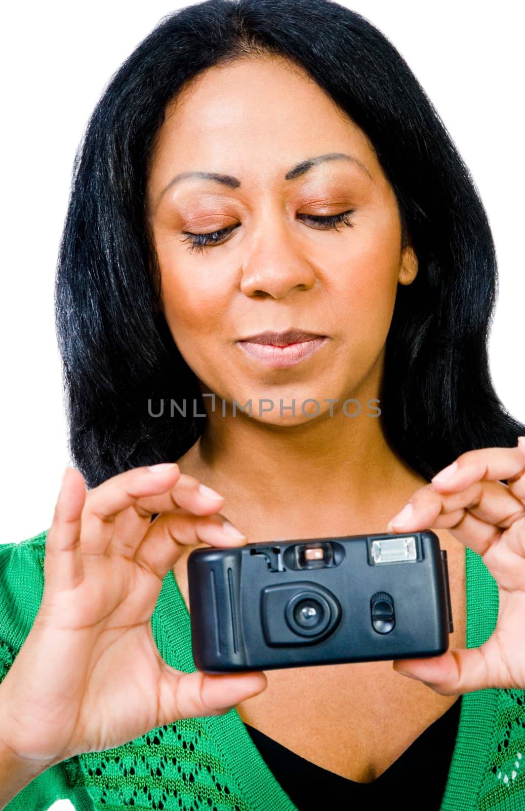 Close-up of a woman photographing with a camera and smiling isolated over white