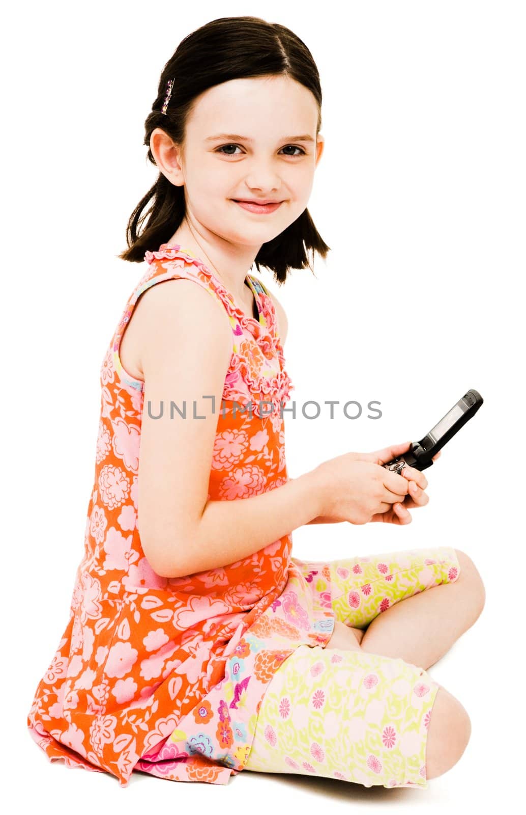 Smiling girl text messaging on a mobile phone isolated over white