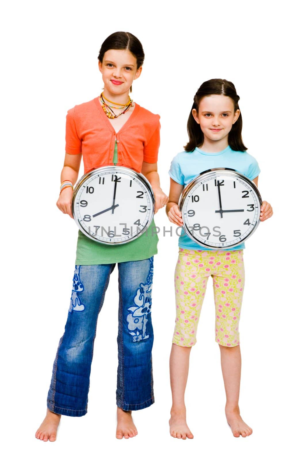 Portrait of girls holding clocks isolated over white