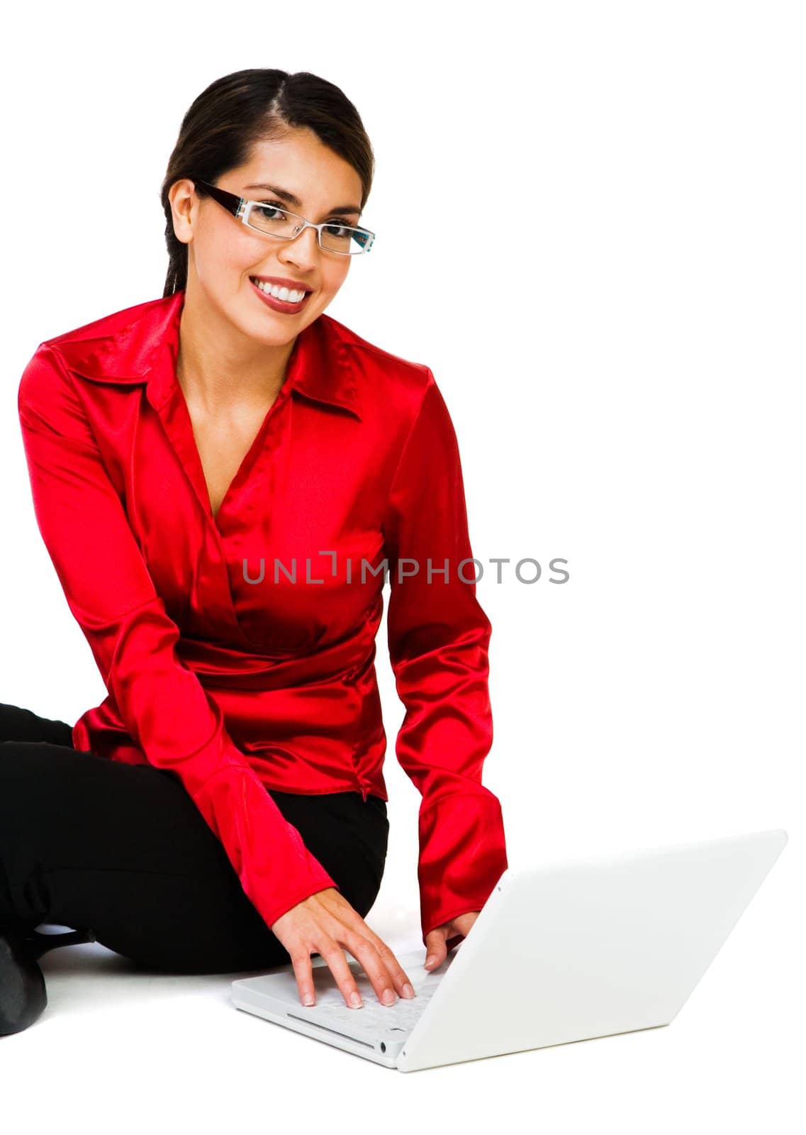 Portrait of a woman using a laptop and smiling isolated over white