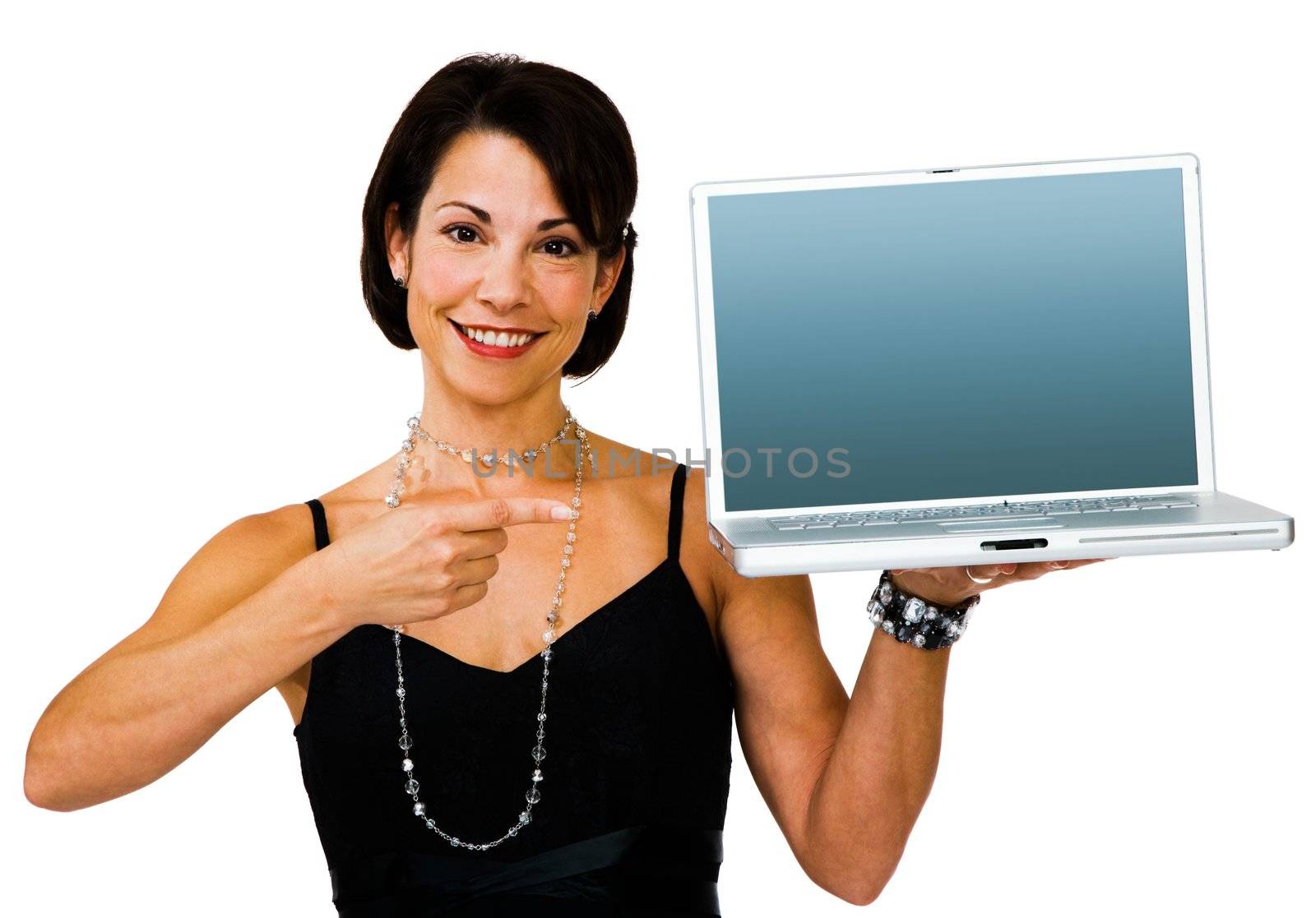 Smiling woman pointing towards a laptop isolated over white