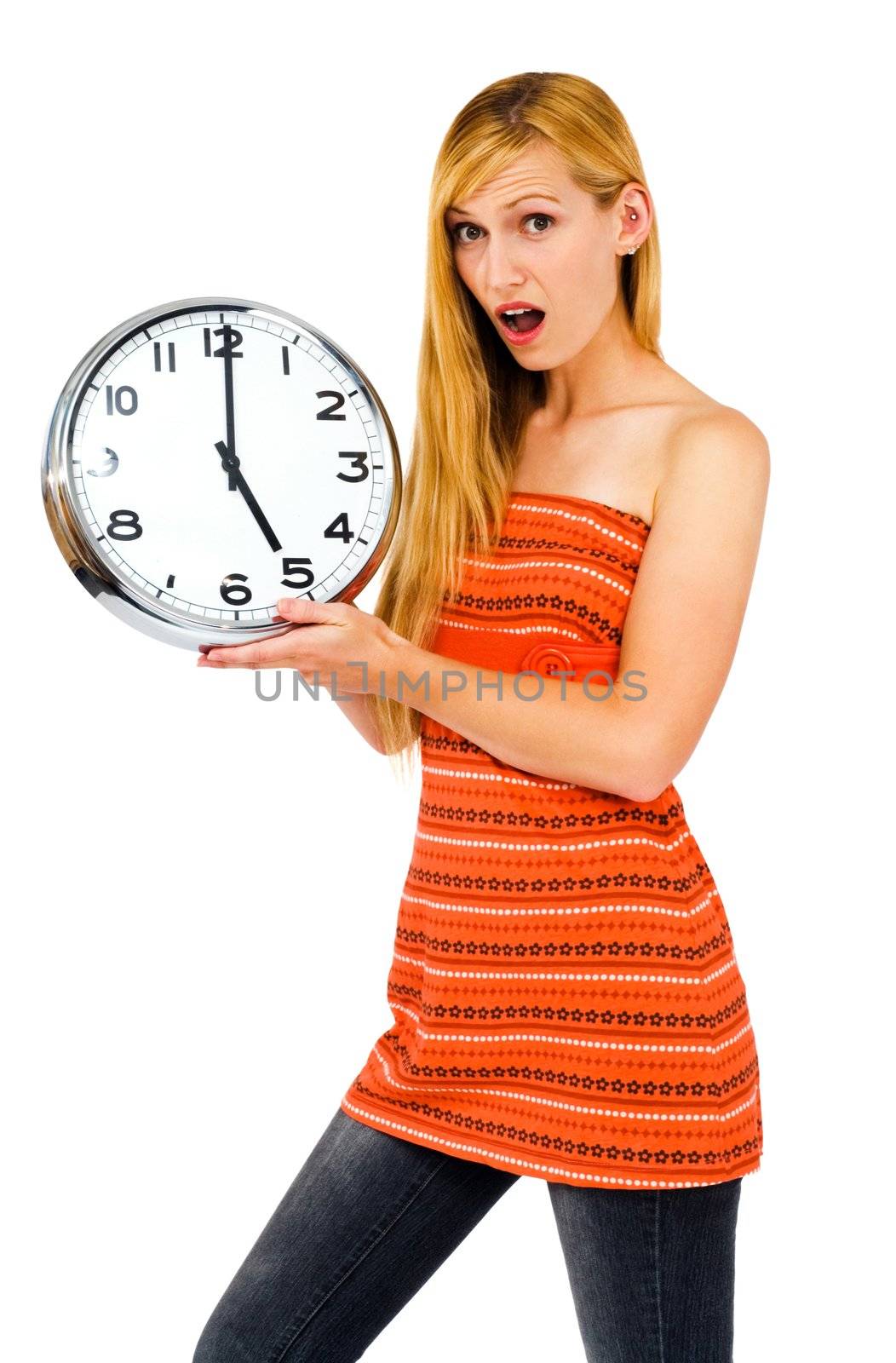 Shocked young woman holding a clock isolated over white