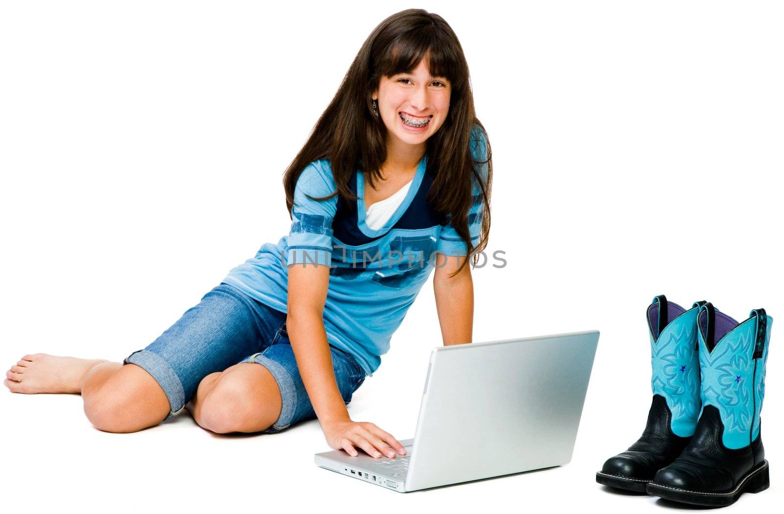 Latin American teenage girl using a laptop  by jackmicro