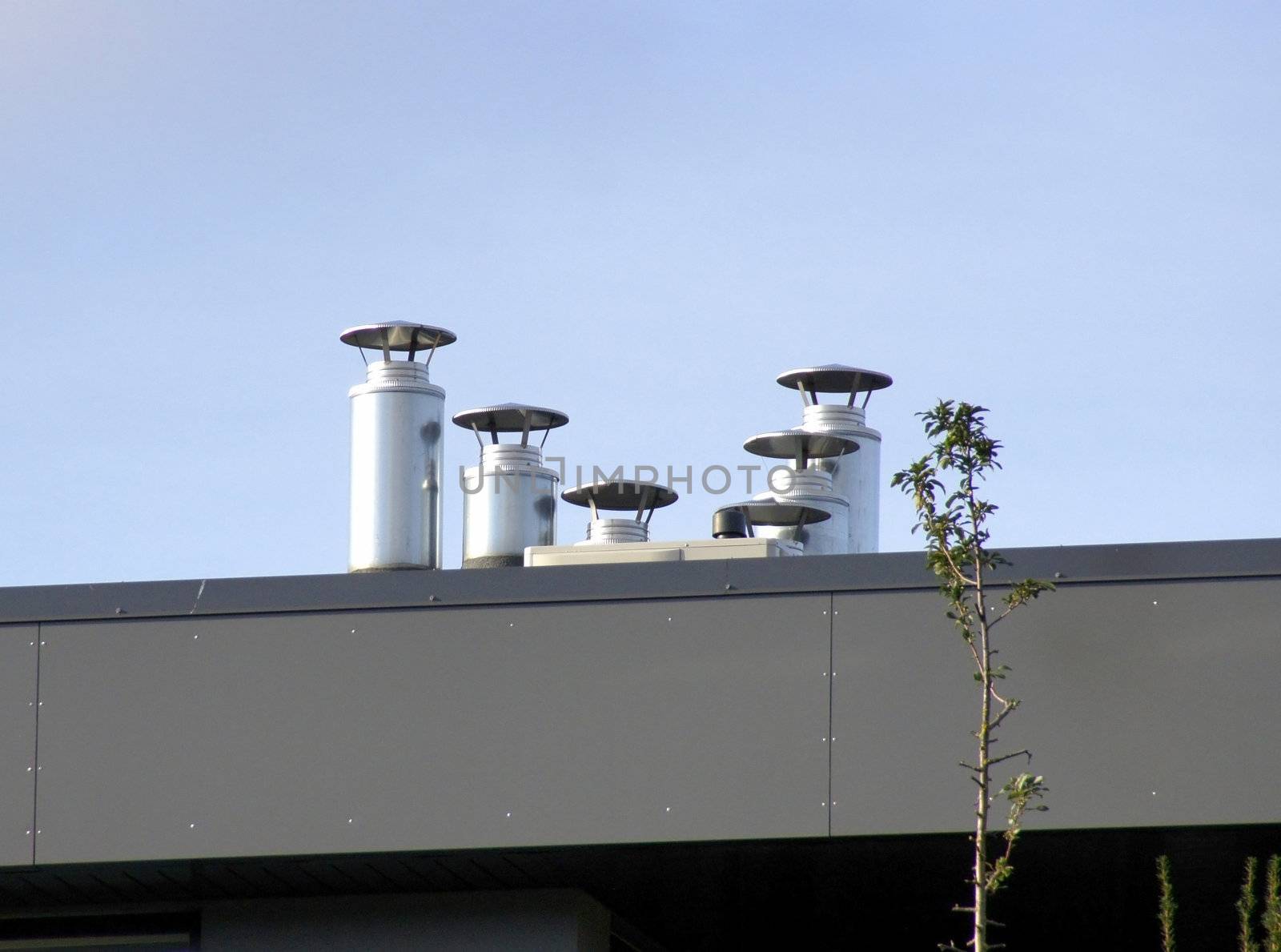 Pipes of ventilation on a background of the blue sky