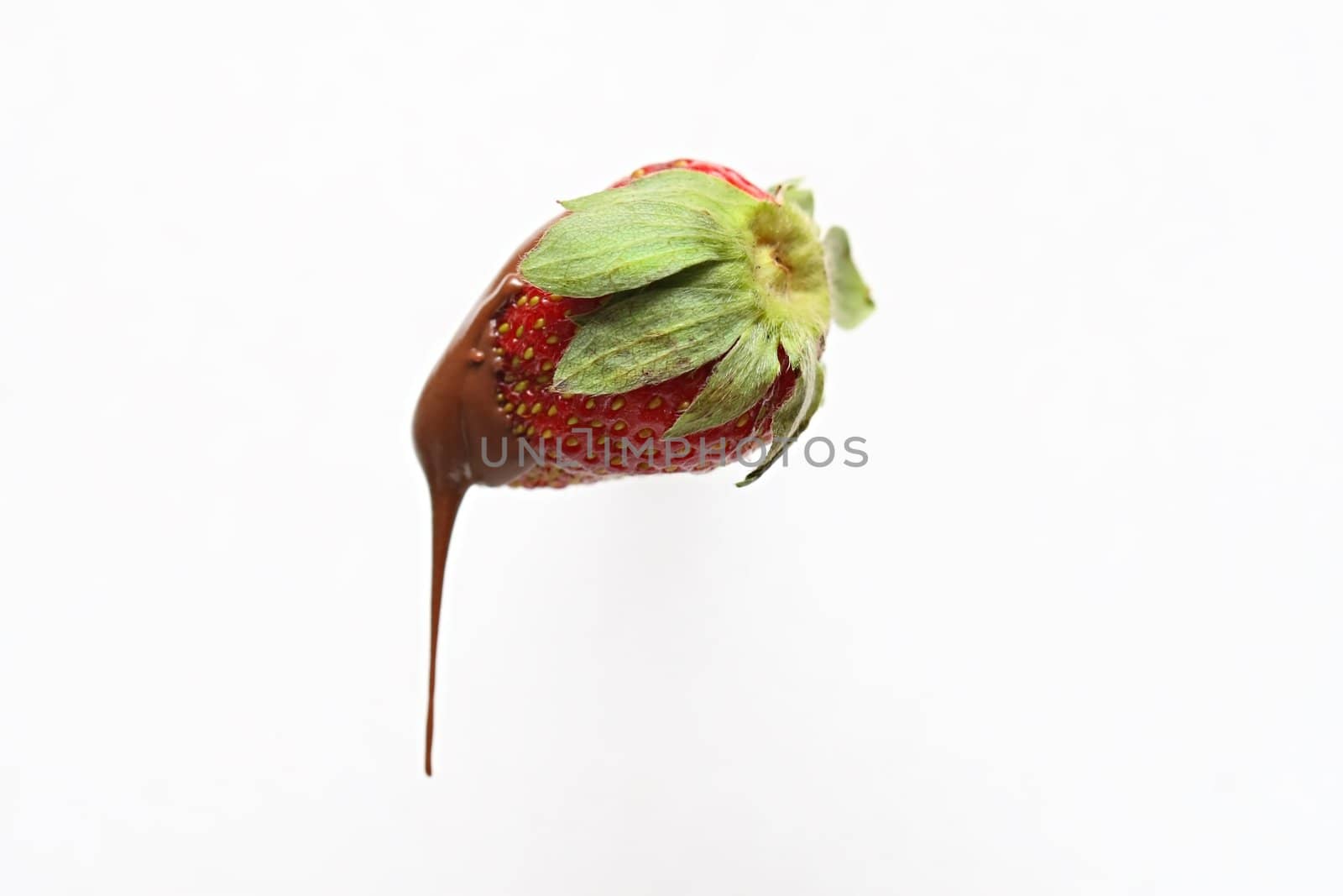 A strawberry dripping with chocolate