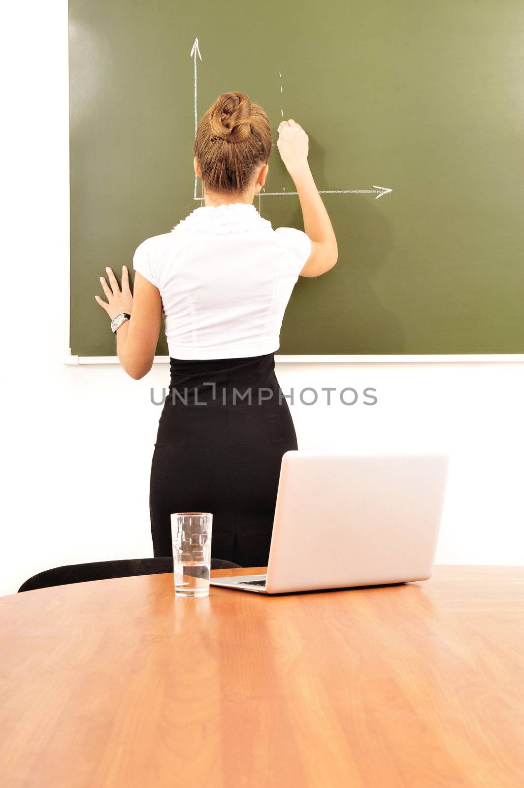 young modern teacher drawing a diagram