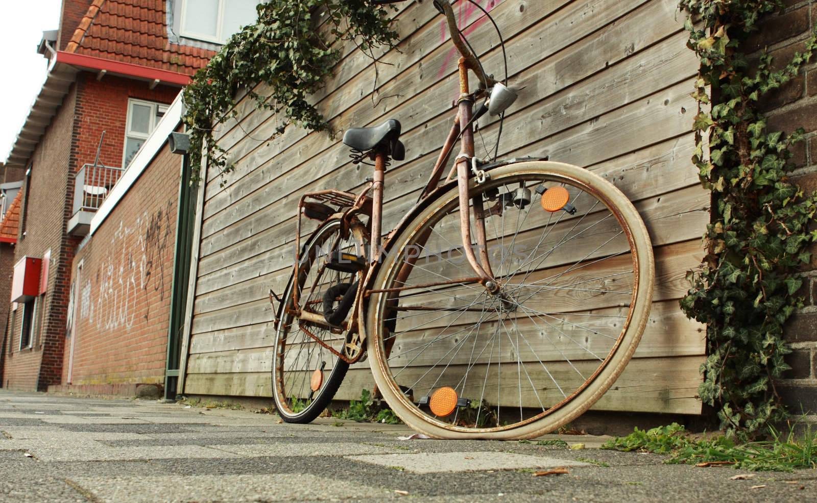 old rusty bike standing on the street