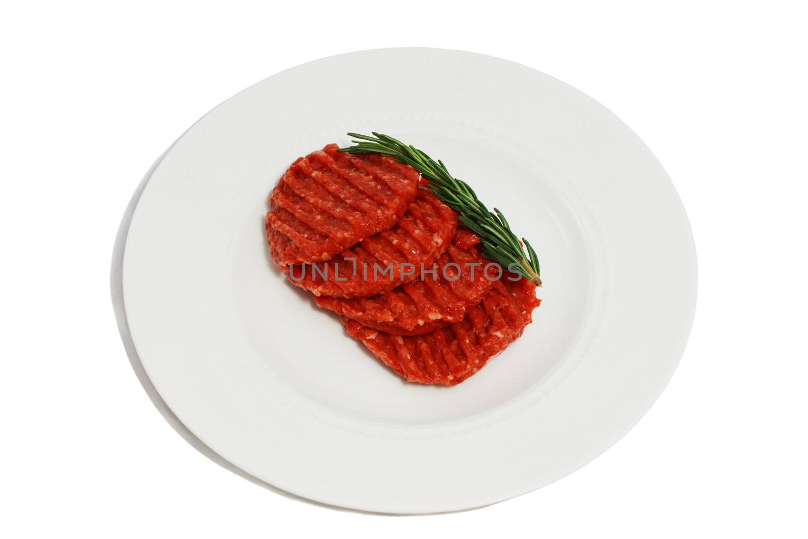 raw meat for barbecue with rosemary on the white plate isolated