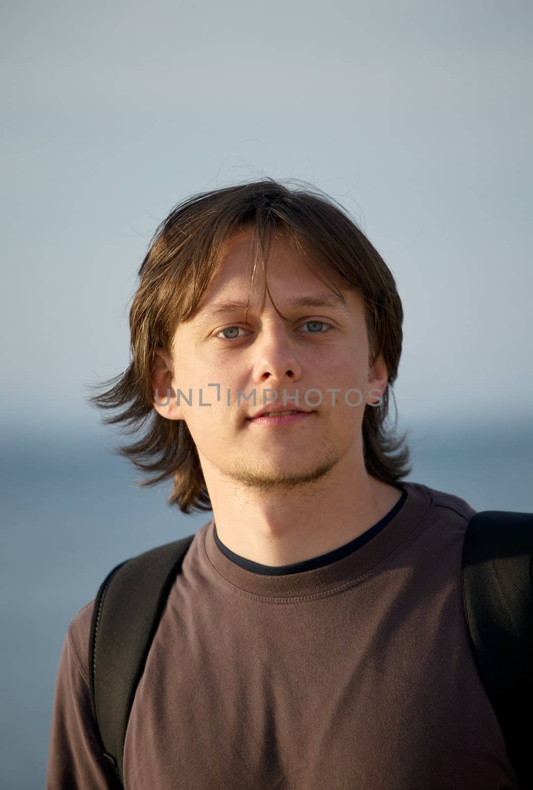 Young man portrait against blue sky