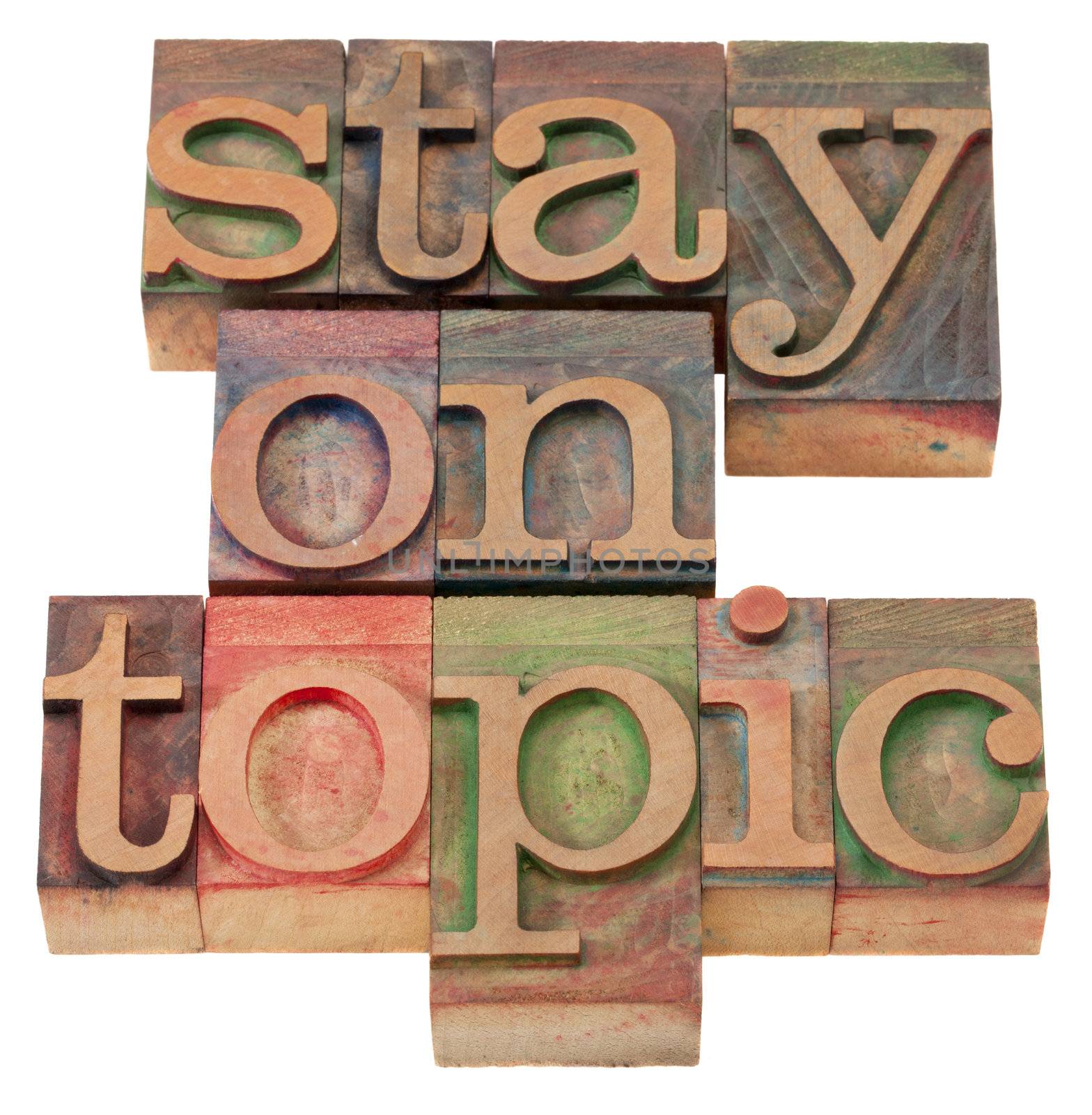 communication concept - stay on topic phrase in vintage wood letterpress printing blocks, isolated on white