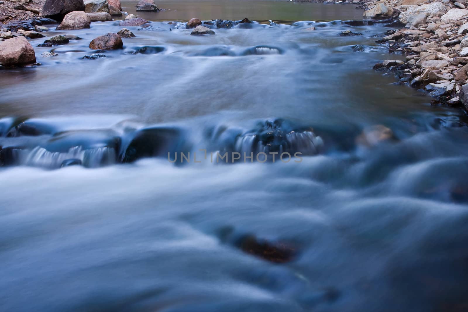 Rapids Running Fast on a bend at a river.