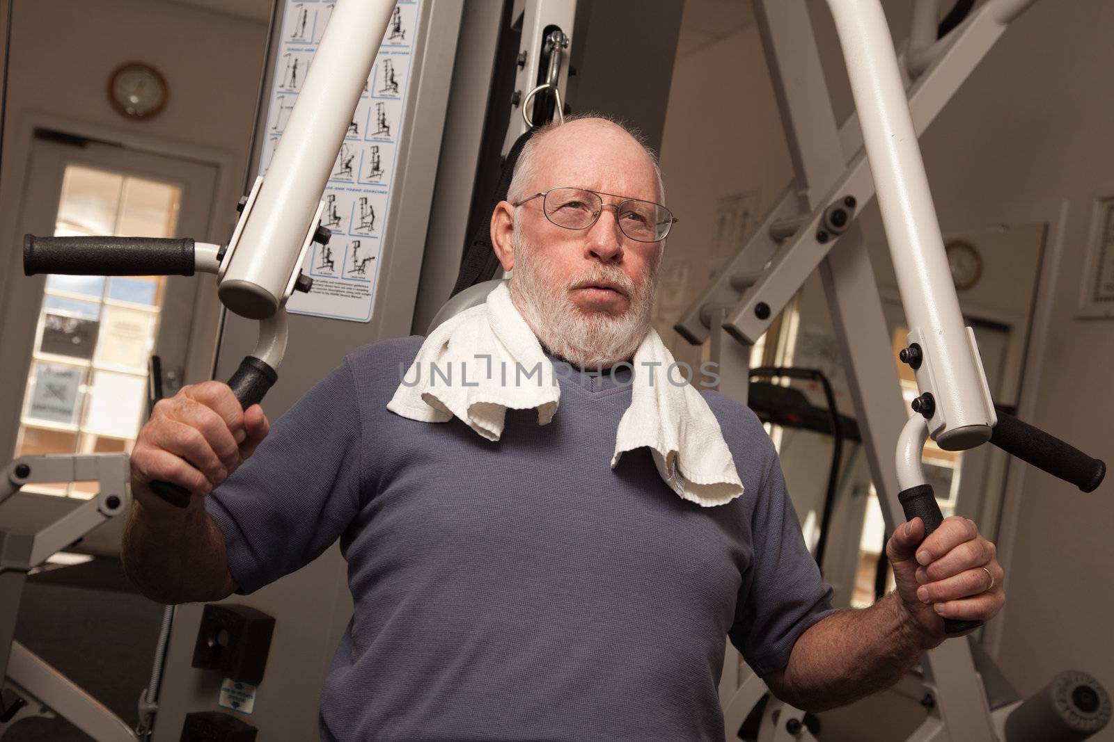 Active Senior Adult Man Working Out in the Gym.