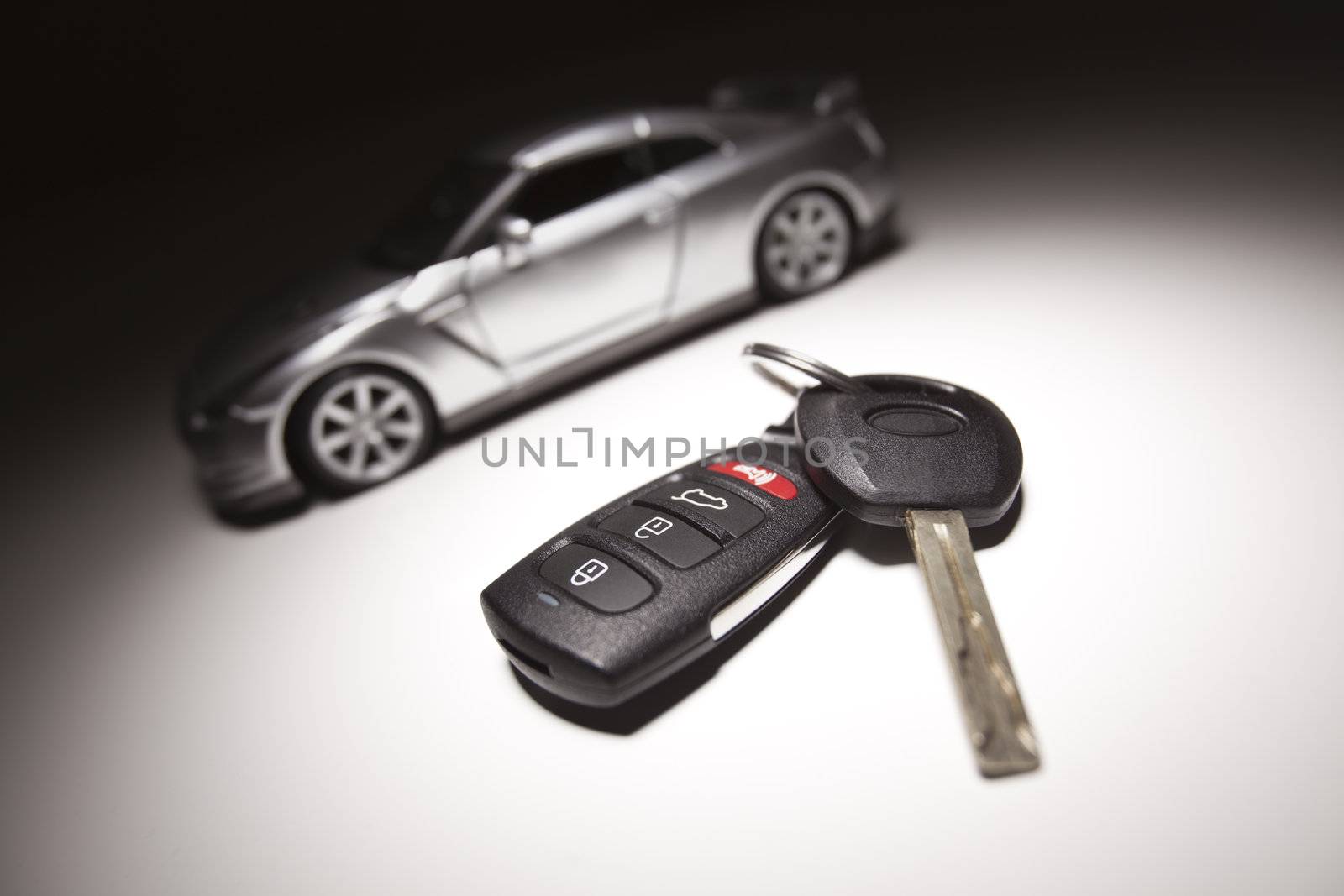 Car Key, Remote and Sports Car Under Spot Light.