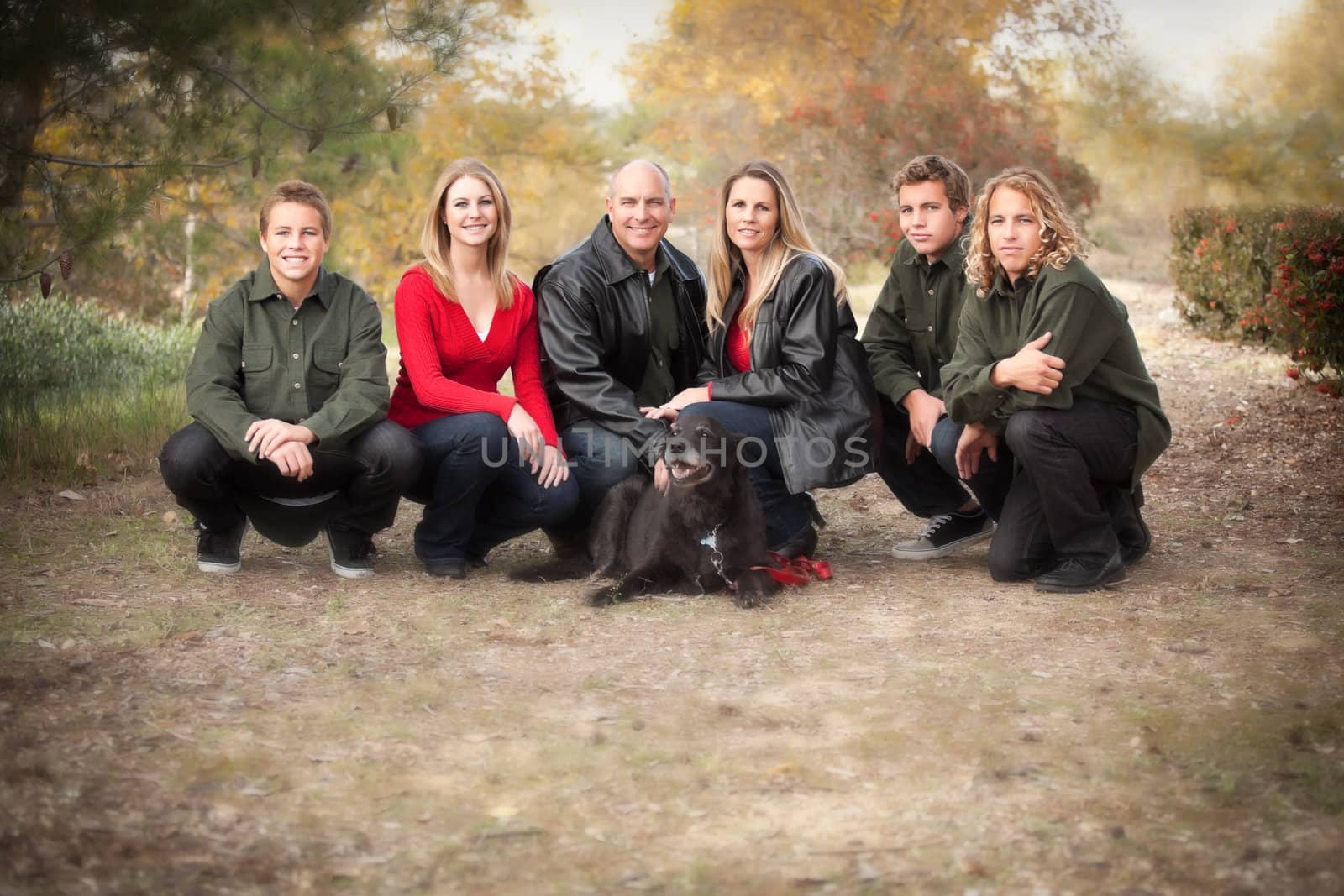 Happy, Attractive Family Pose for a Portrait Outdoors.