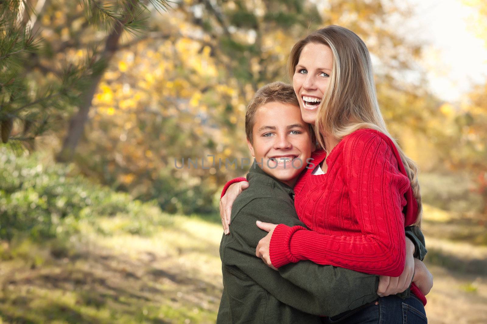 Playful Mother and Son Pose for a Portrait Outdoors by Feverpitched