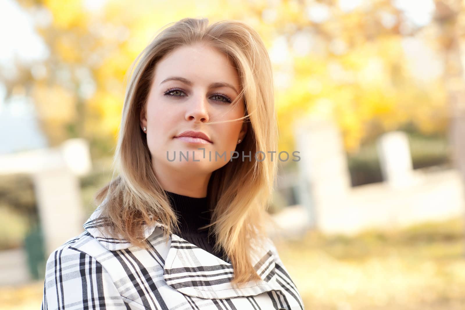 Pretty Young Woman Smiling in the Park on a Fall Day.