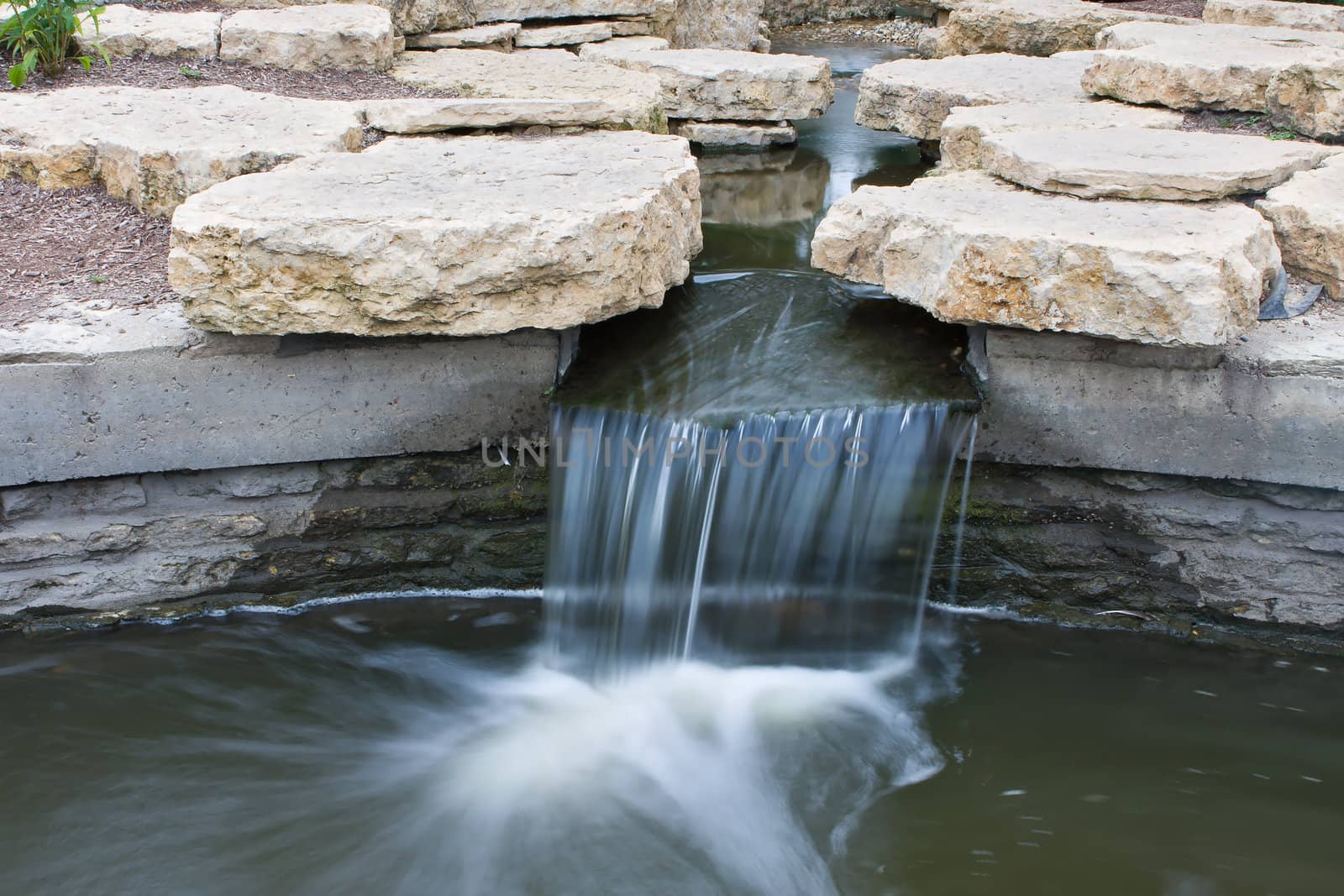 Small waterfall that empties into a river.