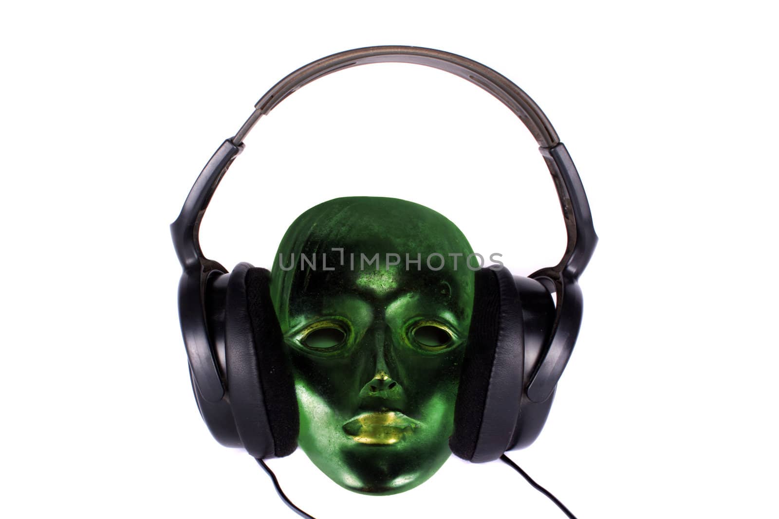 An antique green mask hearing music on the headphones.