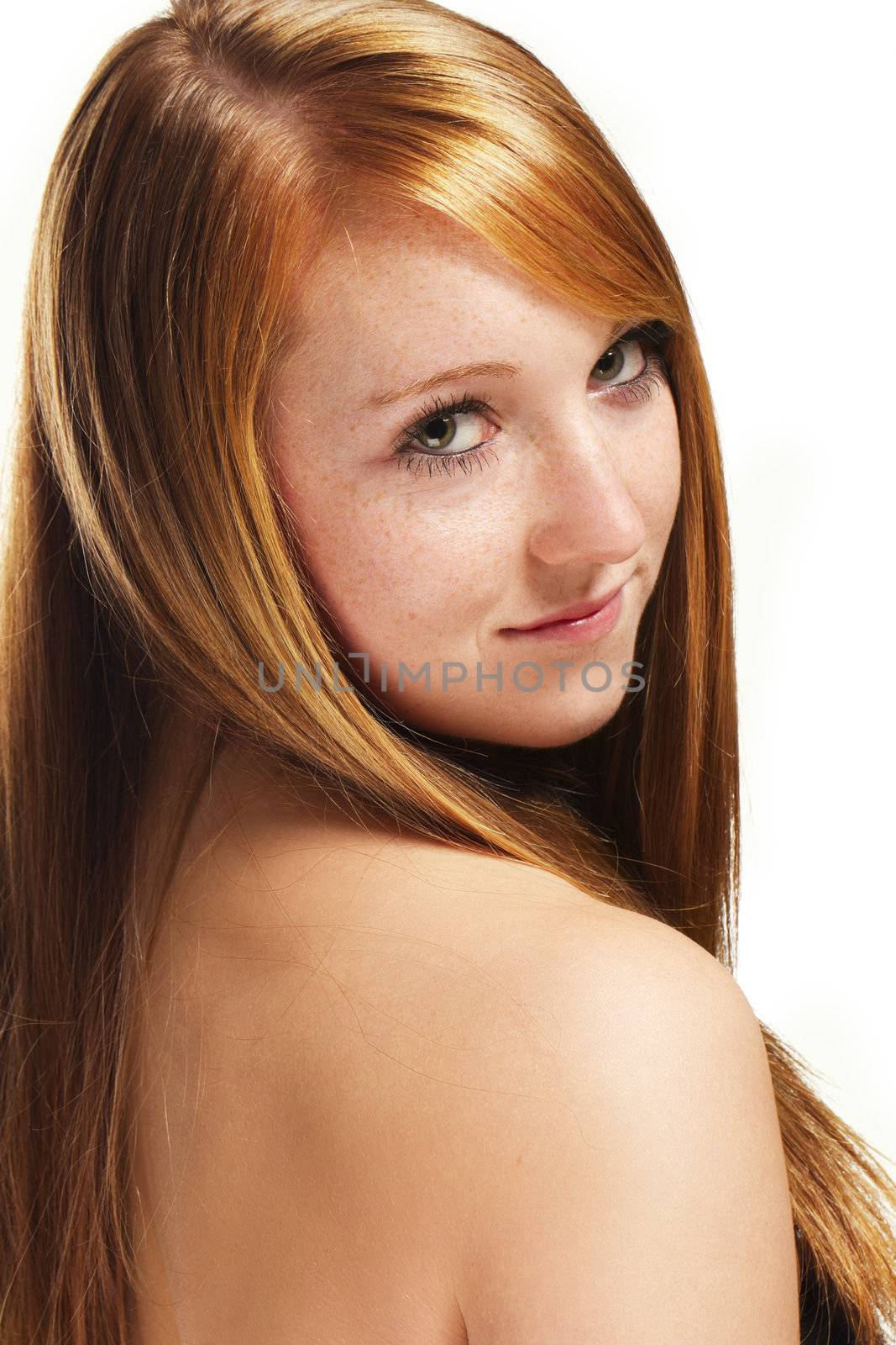 portrait of a redhead girl looking over her shoulder on white background