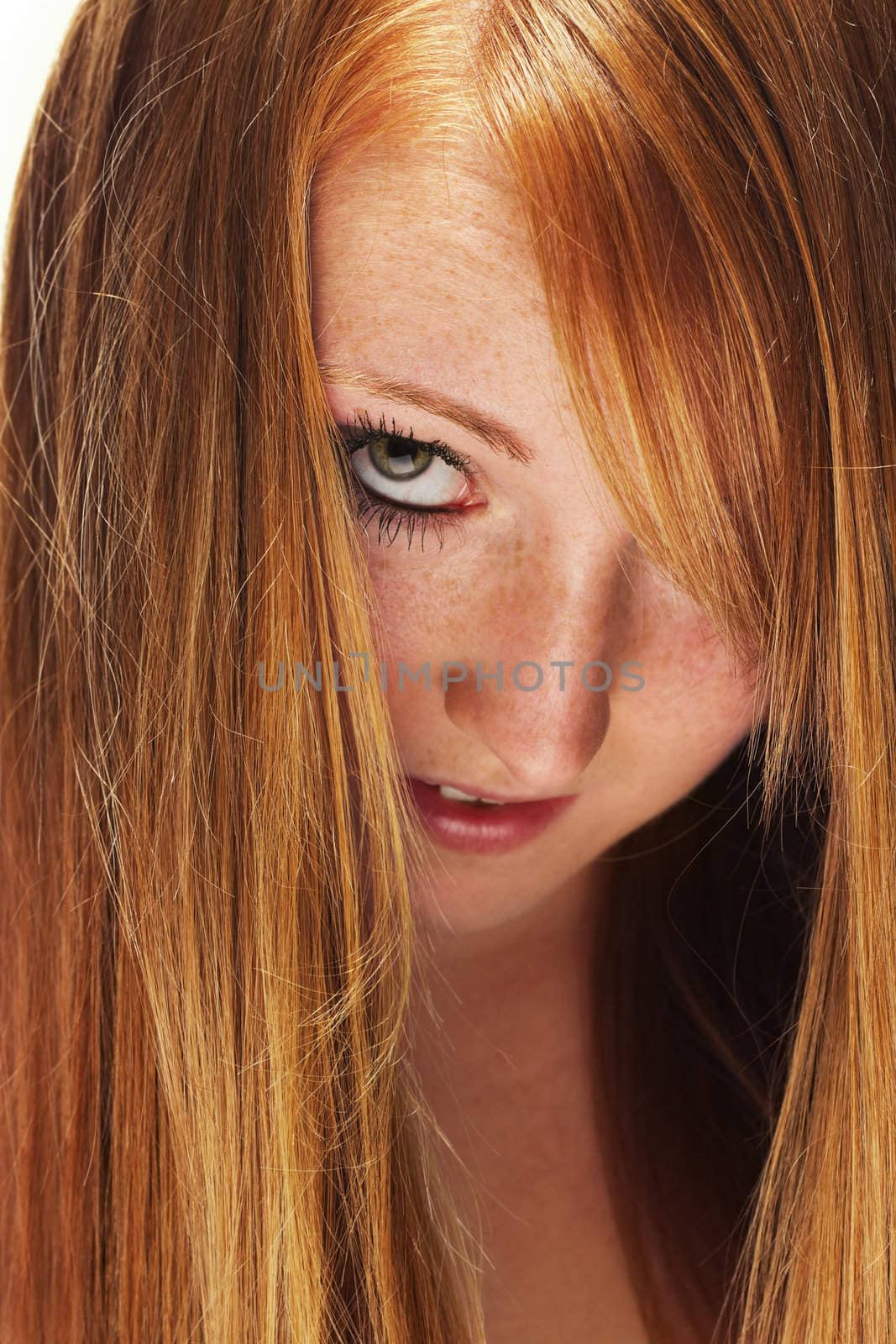 young redhead woman looking through her beautiful hair