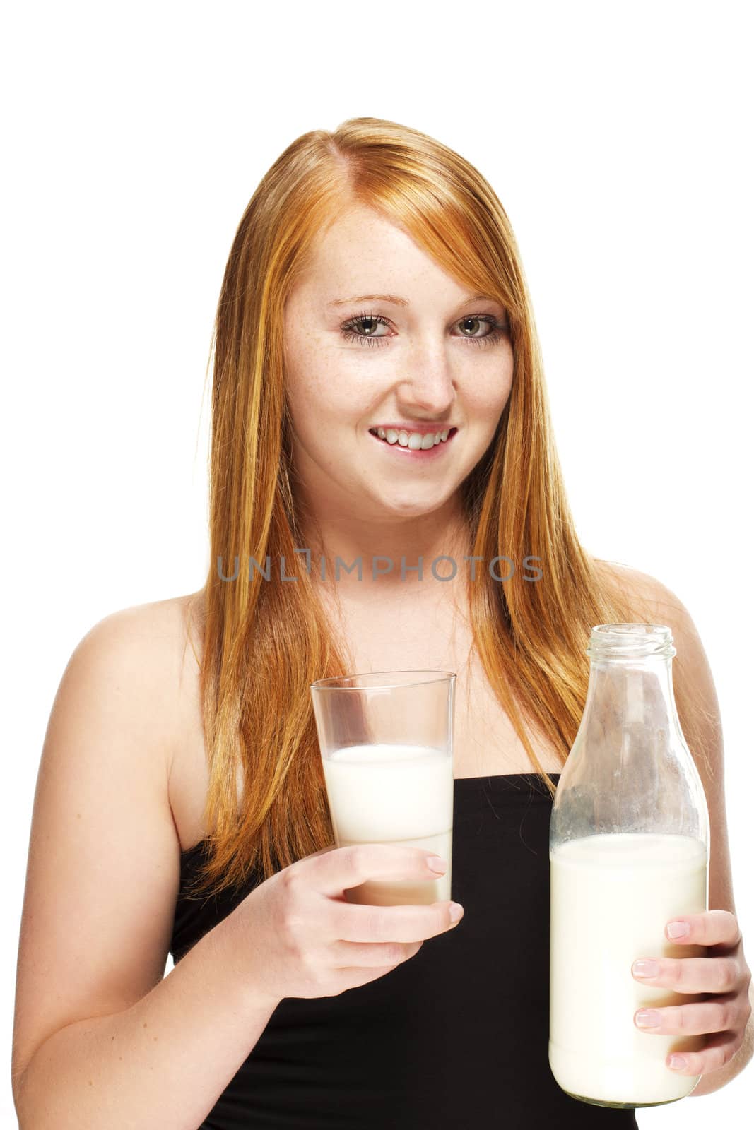 young redhead woman with a glass and a bottle with milk on white background
