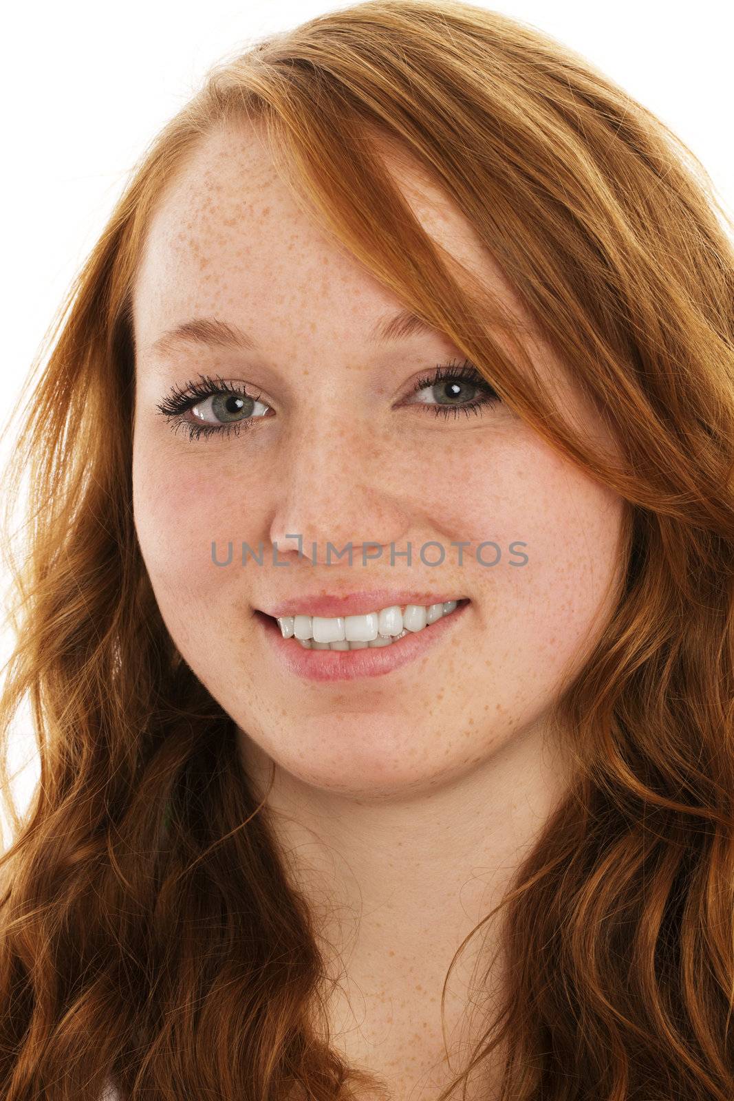 portrait of a young smiling redhead woman on white background