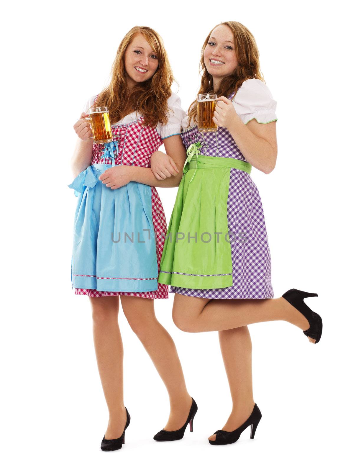 two bavarian women with beer on white background