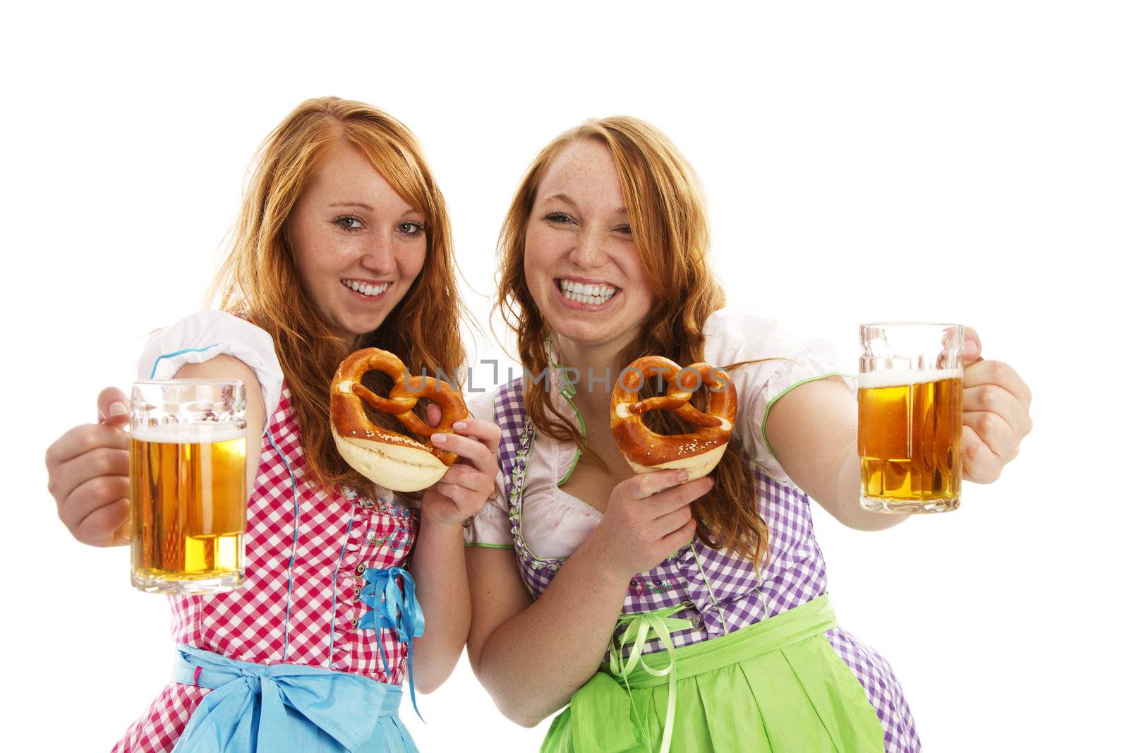 two bavarian girls with pretzels cheering with beer by RobStark