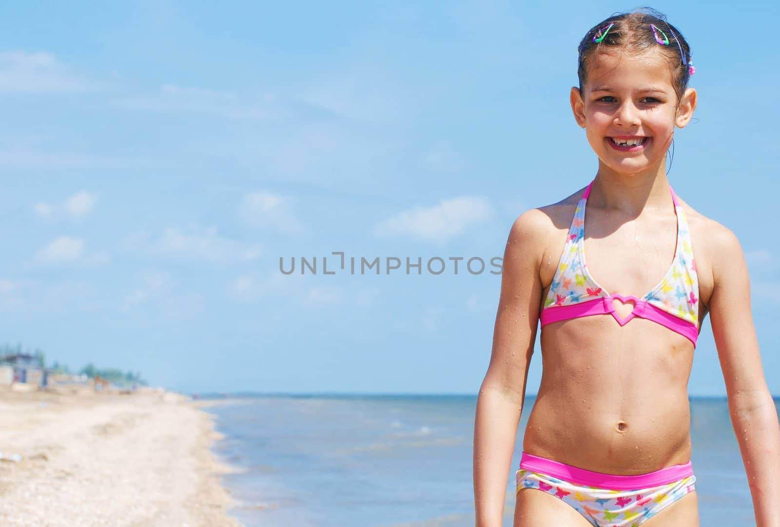 A happy child is running at the beach.